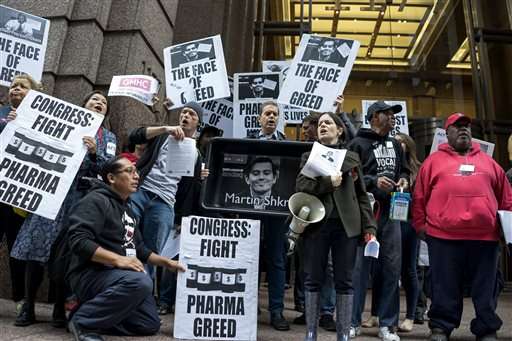 In this Oct. 1, 2015, file photo, activists hold signs containing the image of Turing Pharmaceuticals CEO Martin Shkreli in front the building that houses Turing's offices, during a protest in New York highlighting pharmaceutical drug pricing. Americans from across the political spectrum are worried about the cost of prescription drugs for serious diseases, following weeks of news coverage about companies hiking prices for critical medicines. Keeping drugs for cancer, hepatitis, HIV and other conditions affordable is the top health priority for Democrats, Republicans and independents, according to a poll released Wednesday, Oct. 27, by the nonpartisan Kaiser Family Foundation. (AP Photo/Craig Ruttle, File)