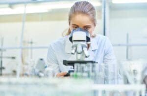 Female Scientist Using Microscope in Laboratory