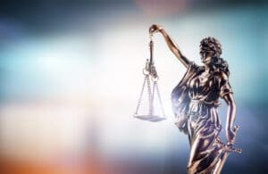 Themis, symbol of law on modern background. Court, legal system and justice.