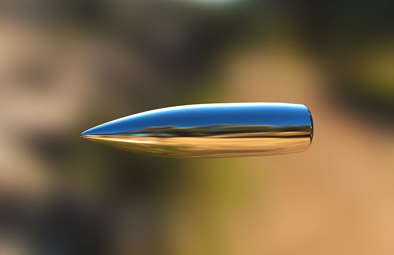 Macro shot of silver bullet caught in flight