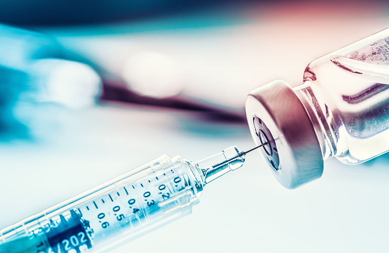 Close-up medical syringe with a vaccine.