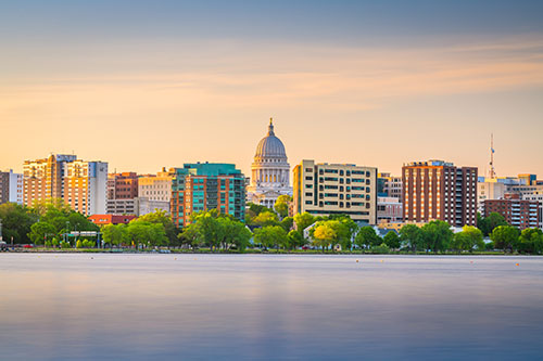 Madison, Wisconsin, USA downtown skyline at dusk on Lake Monona.