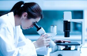 Scientist using a microscope in a laboratory