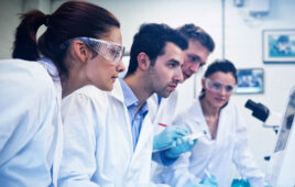 Serious researchers looking at computer screen in the lab