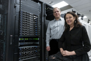 Jonathan Silverstein, professor and chief research informatics officer, and Kay Métis, Executive Director Programs and Strategic Initiatives, in the Network Operations Center (NOC) with the systems that Dell awarded to the University. (Tom Altany/University of Pittsburgh)