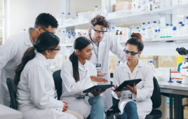 Tablet, science team and people learning for cancer cure, help or medical development in laboratory. Training, investigation or research info with scientists in clinical trial for medicine internship.